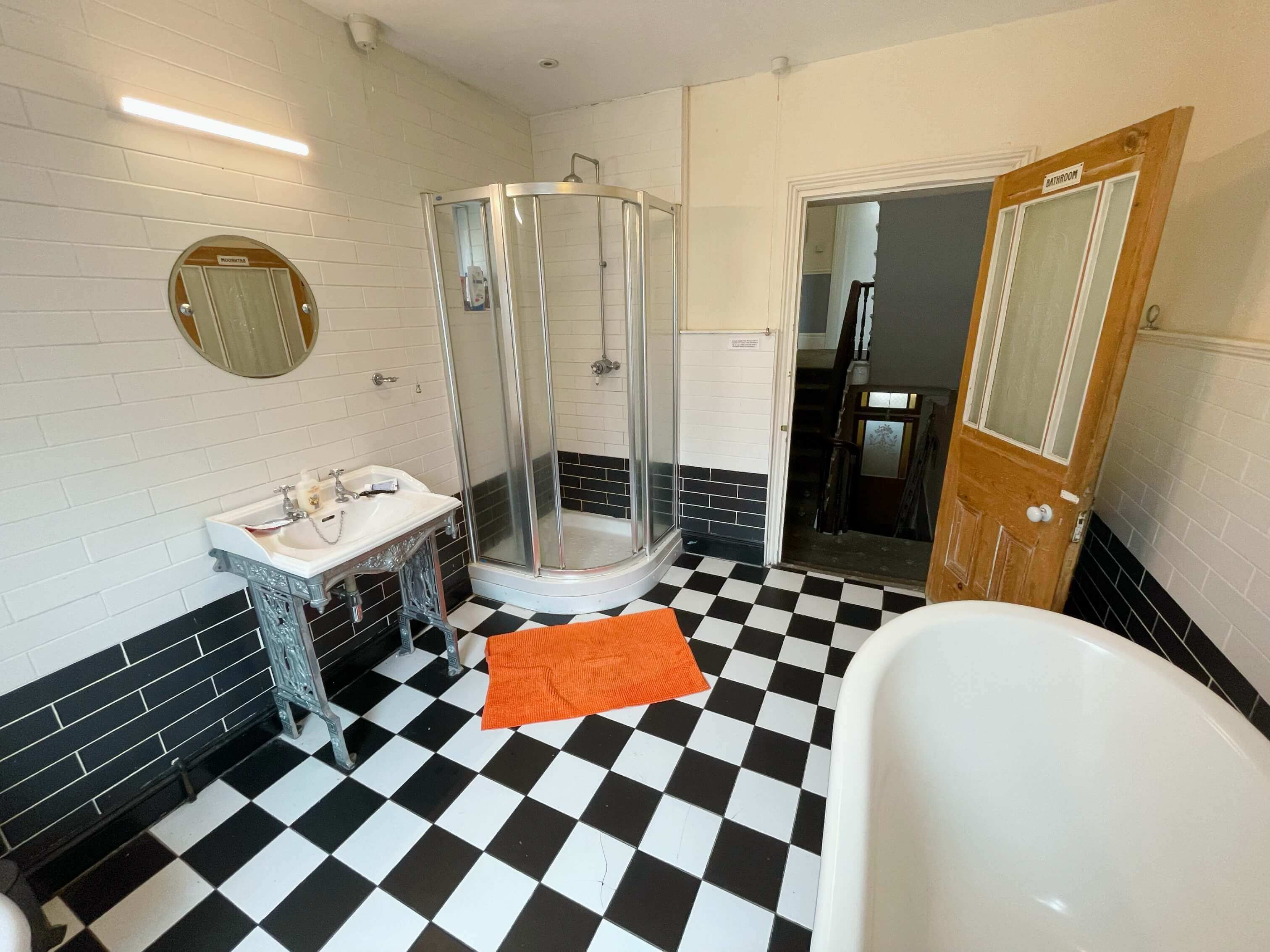 Shared bathroom with large bath and shower